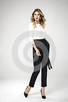 Blonde model posing in her black chic pants