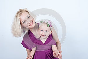 Blonde mom and daughter in Studio on white background