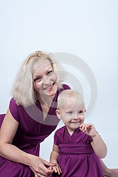 Blonde mom and daughter in Studio on white background