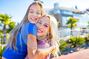 blonde mom and her cute child in summer beach seaside in tropics