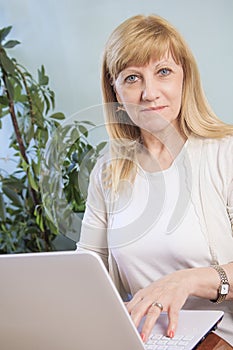 Blonde senior woman browsing internet