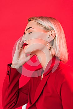 blonde sensual girl posing in red jacket