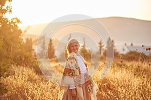 Blonde slavic girl on the field in the evening