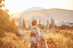 Blonde slavic girl on the field in the evening