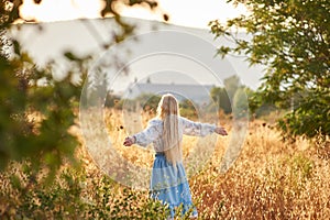 Blonde slavic girl on the field in the evening