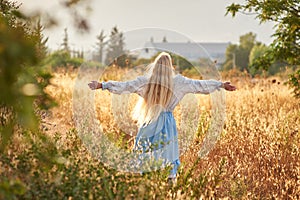 Blonde slavic girl on the field in the evening