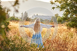 Blonde slavic girl on the field in the evening