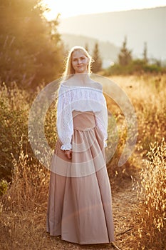 Blonde slavic girl on the field in the evening