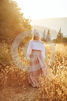 Blonde slavic girl on the field in the evening