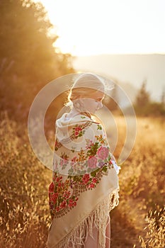 Blonde slavic girl on the field in the evening