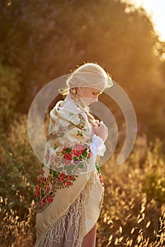 Blonde slavic girl on the field in the evening