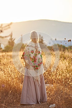 Blonde slavic girl on the field in the evening