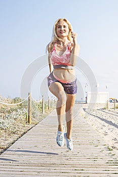 Blonde sporty girl running for the promenade