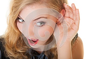 Blonde surprised gossip girl with hand behind ear listening secret