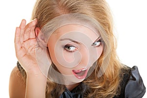 Blonde surprised gossip girl with hand behind ear listening secret