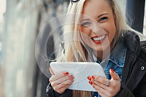 Blonde tourist uses tablet for European adventures