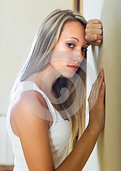 Blonde unhappy woman at home