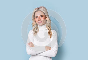 Blonde woman adult attractive beautiful smiling portrait, cauasian and scandinavian girl on blue background photo