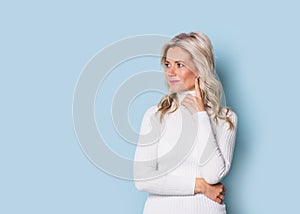 Blonde woman adult attractive beautiful smiling portrait, cauasian and scandinavian girl on blue background photo