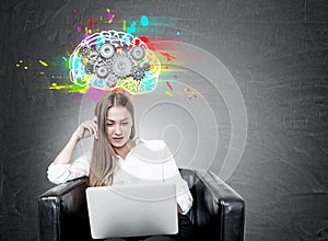 Blonde woman in armchair, laptop, brain cogs