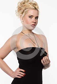 Blonde woman with beautiful curls posing on a light background. Girl with curly hairstyle and lips