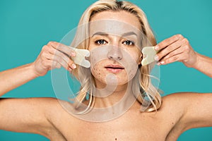 blonde woman with blemishes using face