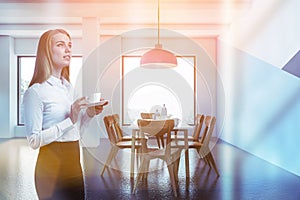 Blonde woman in blue and white dining room