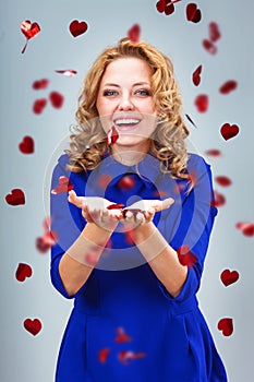 Blonde woman catching heart shapes