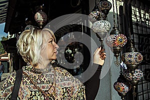 Blonde woman choosing a souvenir in Sarajevo