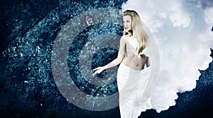 Blonde Woman in Cloud Dress at Grunge Blue Wall