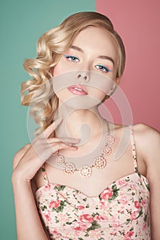 Blonde woman with color makup on colorful background