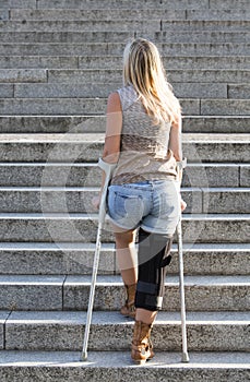 Blonde woman with crutches