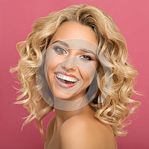 Blonde woman with curly beautiful hair smiling