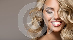 Blonde woman with curly beautiful hair smiling photo