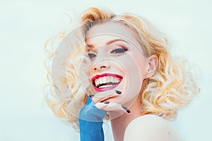 Blonde woman with curly beautiful hair smiling on white background isolated.