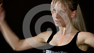Blonde woman dances go-go Training Wet sweat Spotted Separate movements Slowmotion black background