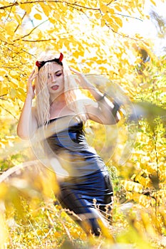 Blonde woman in devil costume. Outdoor