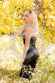 Blonde woman in devil costume. Outdoor