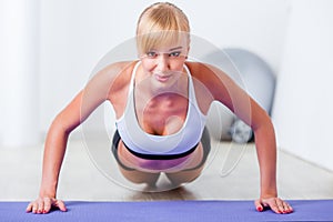 Blonde woman doing push-ups