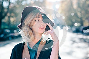 Blonde woman dreaming in hat closeaup fashion outdoors lifestyle