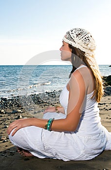 Blonde woman dressed in white on the seashore