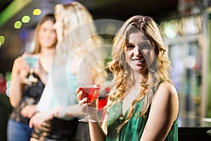 Blonde woman drinking cocktail