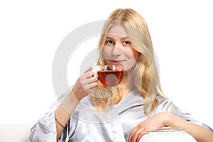Blonde woman drinking a cup of tea