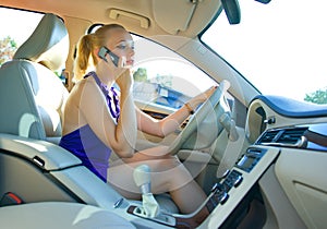 Blonde woman driving and talking to mobile phone