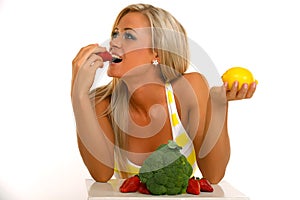 Blonde woman eating strawberry