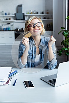 Blonde woman in eyeglasses making purchase