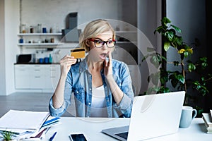 Blonde woman in eyeglasses making purchase