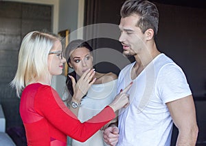 Blonde woman flirting with disloyal man, girlfriend in shock photo
