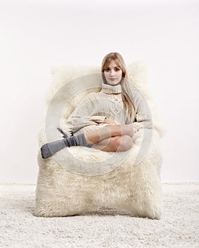 Blonde woman on furry arm-chair