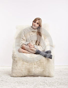 Blonde woman on furry arm-chair